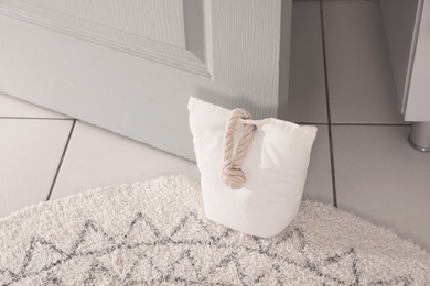 Photo of Stuffed bag holding wooden door at home