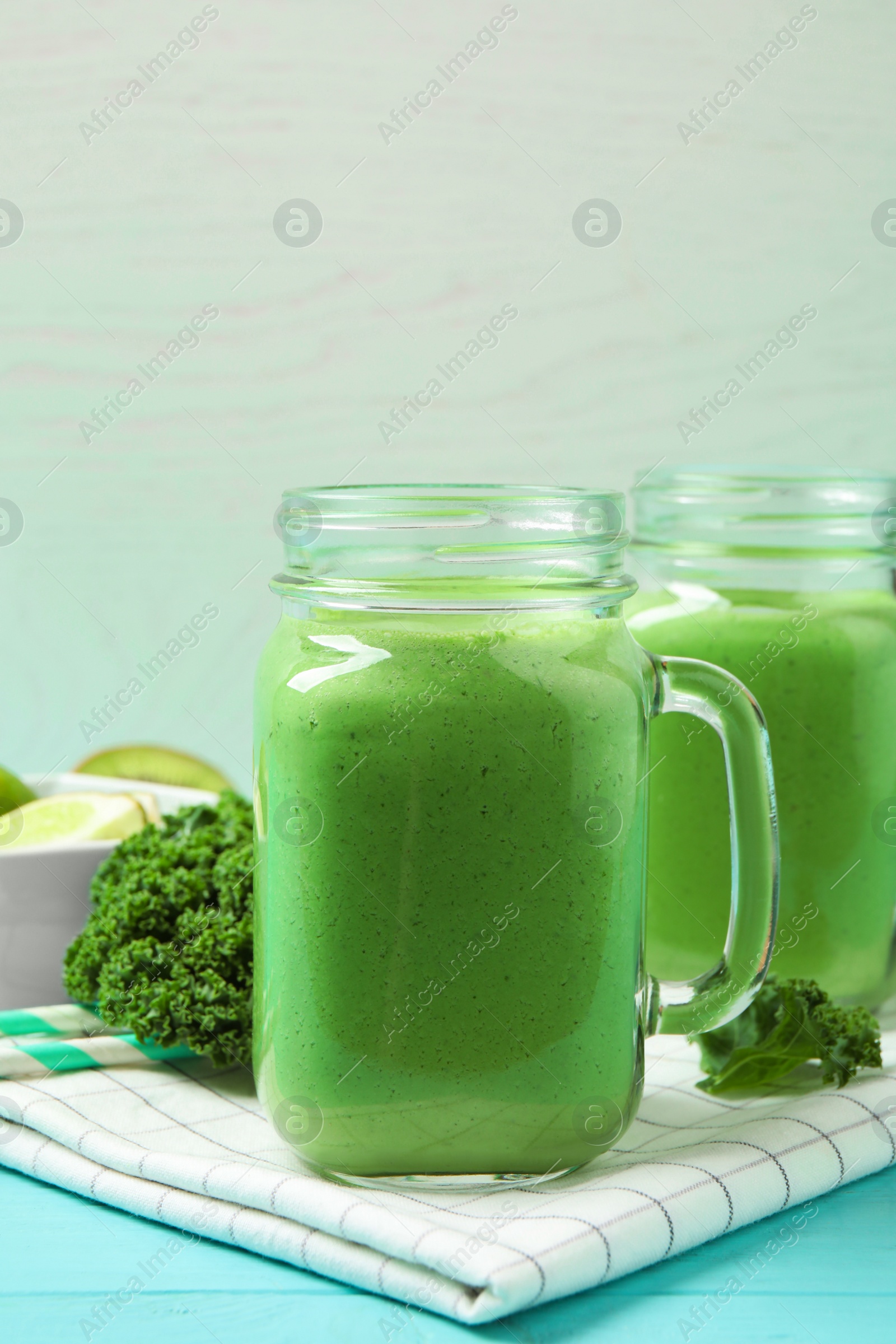 Photo of Tasty fresh kale smoothie on light blue wooden table