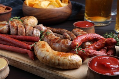 Set of different tasty snacks on wooden table, closeup view