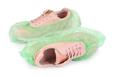 Photo of Sneakers in green shoe covers isolated on white