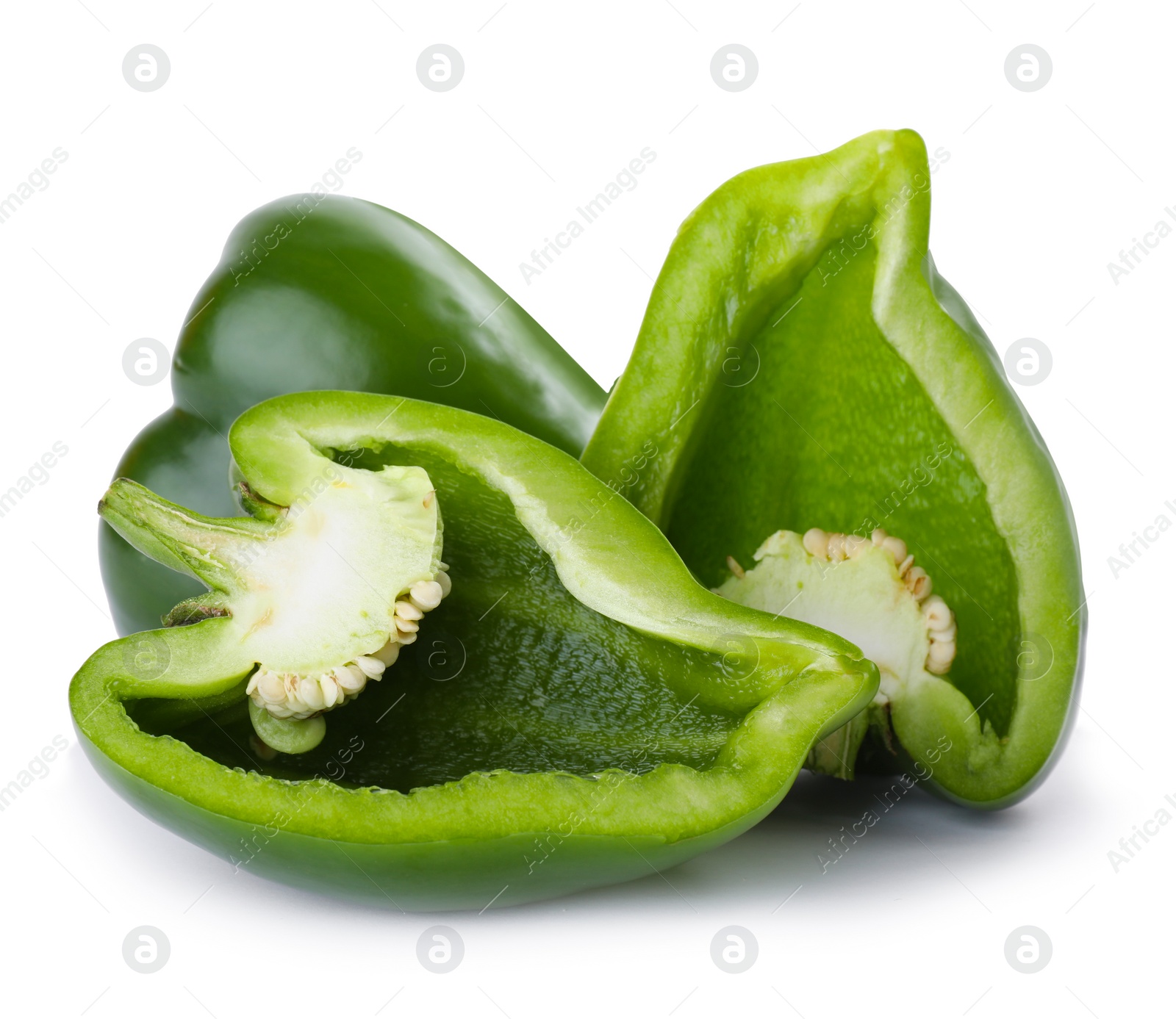 Photo of Whole and cut green bell peppers isolated on white