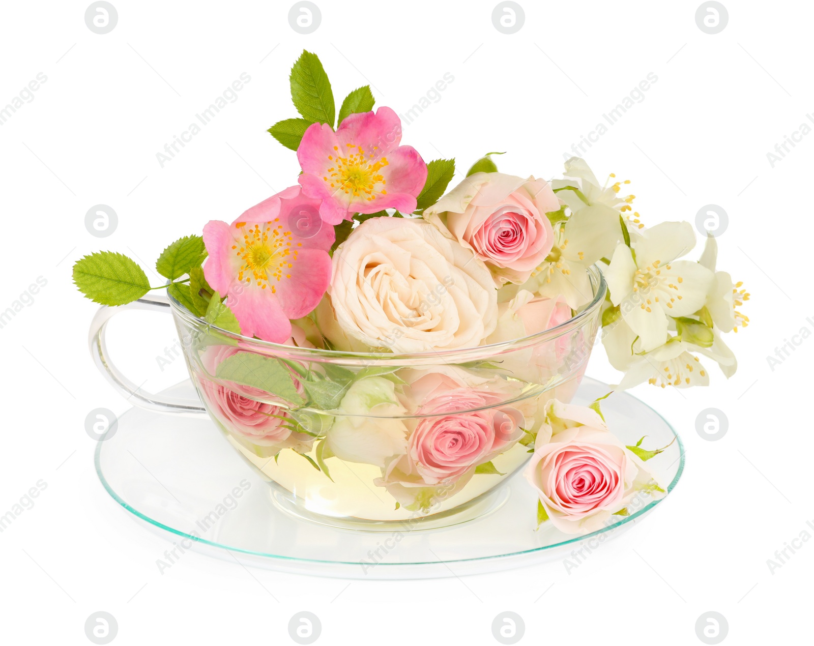 Photo of Aromatic herbal tea in glass cup with different flowers isolated on white