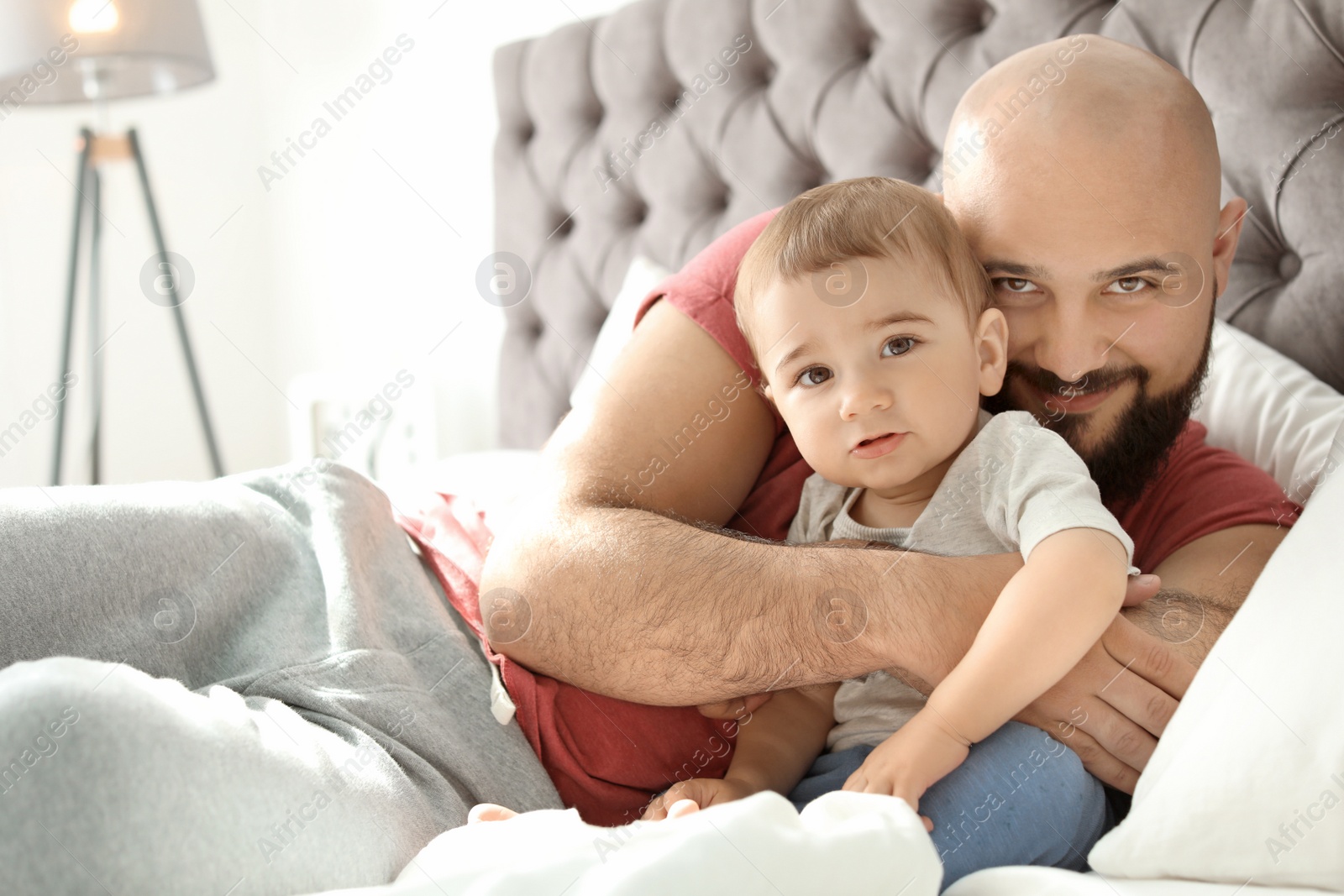 Photo of Dad and his little son spending time together at home