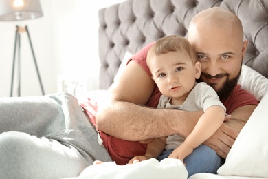 Photo of Dad and his little son spending time together at home