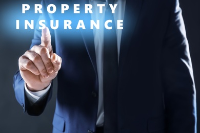 Image of Property insurance concept. Man using virtual screen, closeup
