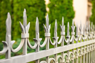 Photo of Railing of beautiful iron fence outdoors, closeup