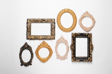Empty vintage frames hanging on white wall