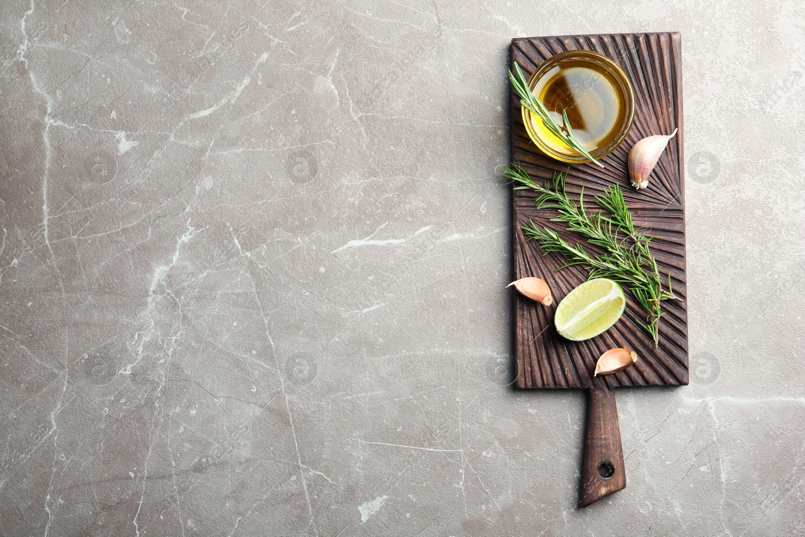 Photo of Flat lay composition with fresh rosemary oil on grey background