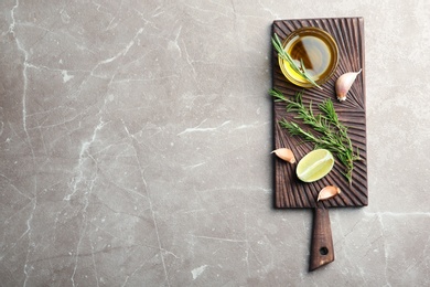 Photo of Flat lay composition with fresh rosemary oil on grey background