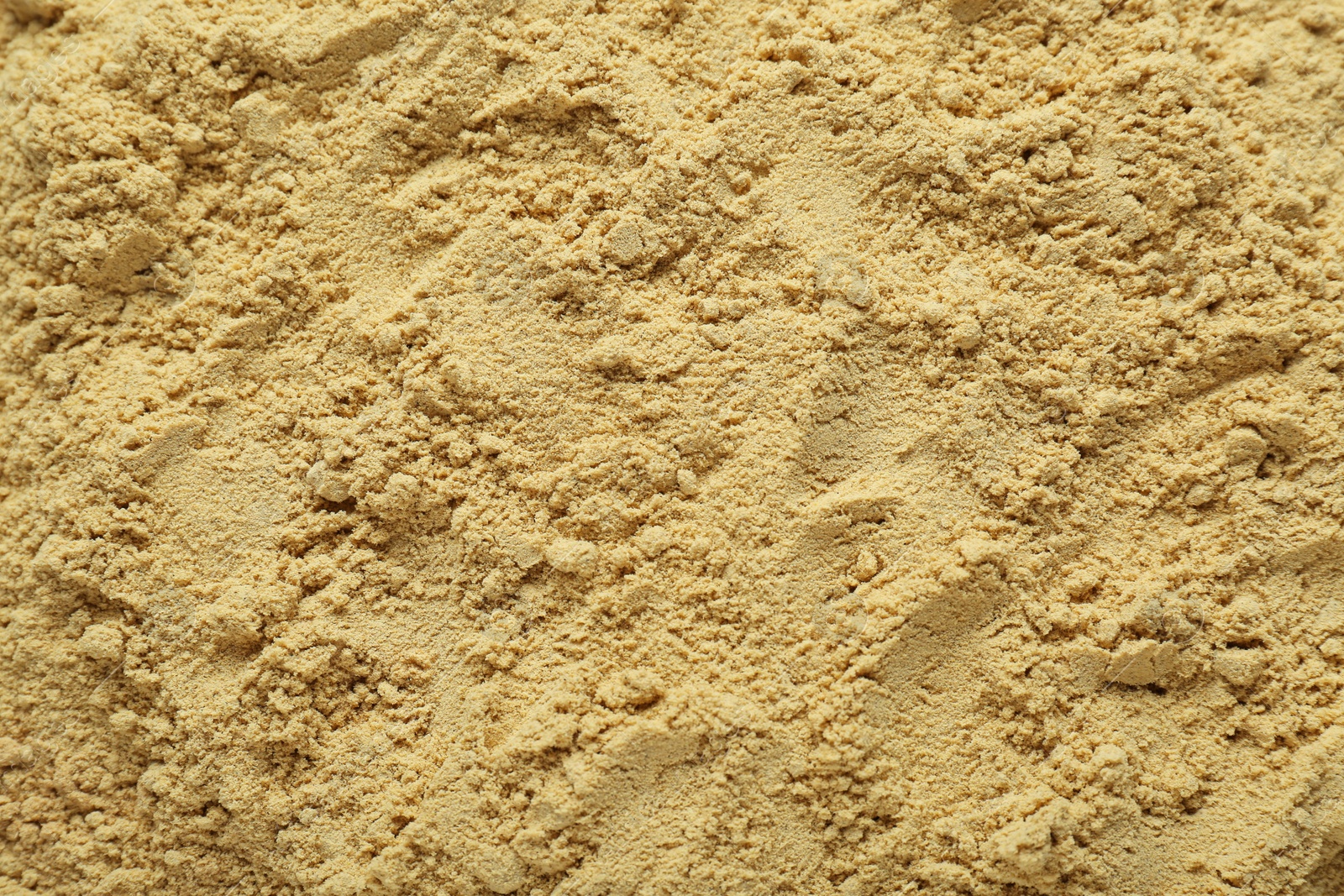 Photo of Aromatic mustard powder as background, top view