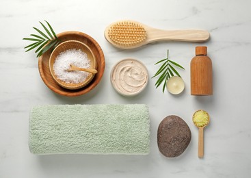 Flat lay composition with different spa products on white marble table