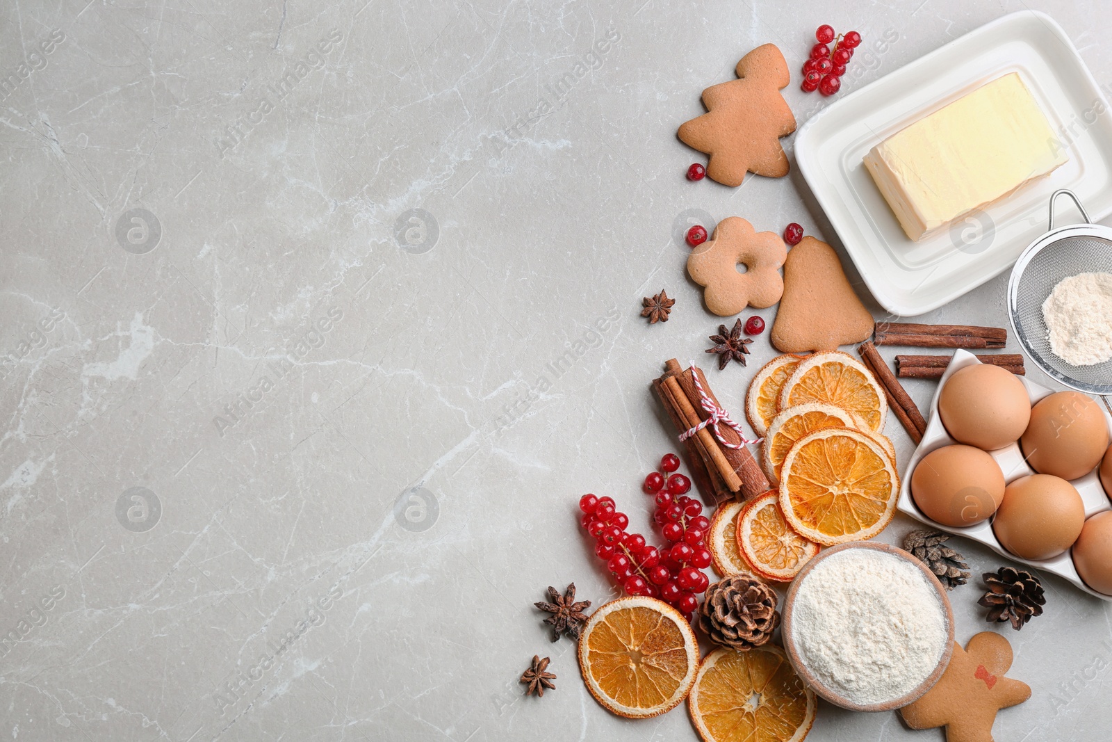 Photo of Flat lay composition with homemade Christmas cookies and ingredients on grey table, space for text