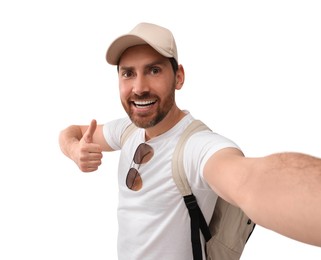 Smiling man taking selfie and showing thumbs up on white background