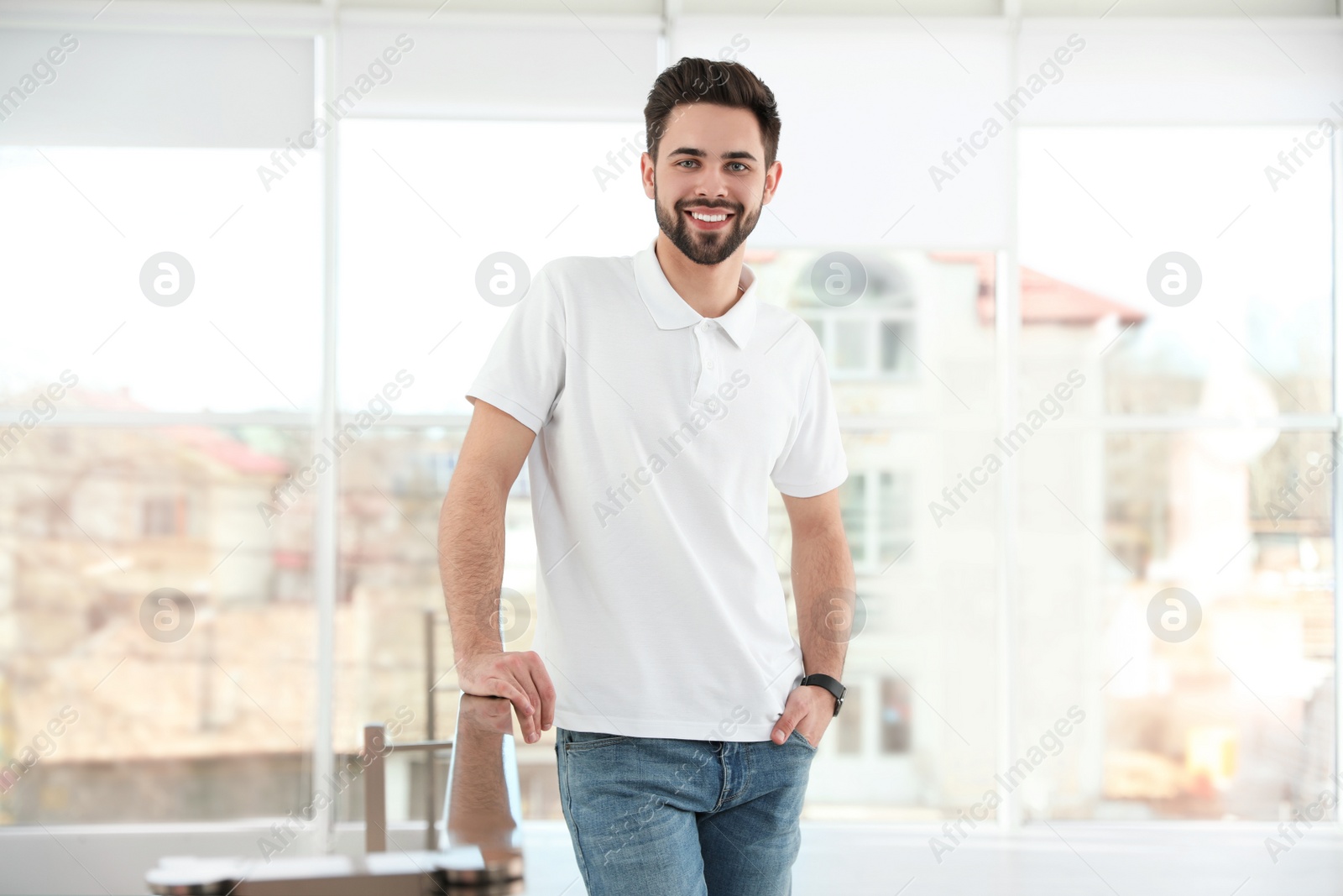 Photo of Portrait of handsome man smiling in light room