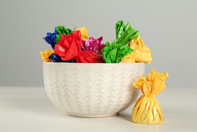 Photo of Candies in colorful wrappers on light table