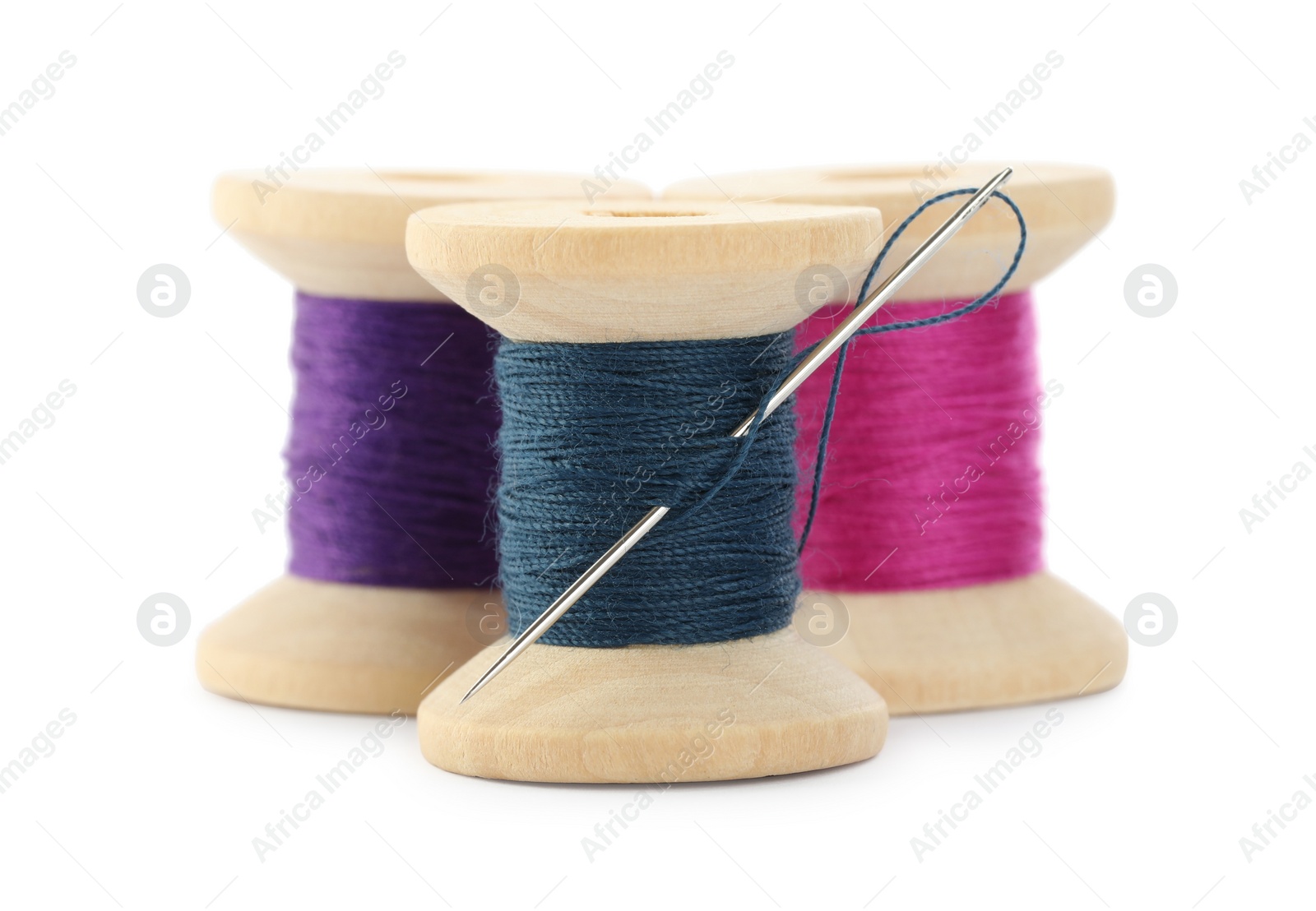 Photo of Different colorful sewing threads with needle on white background