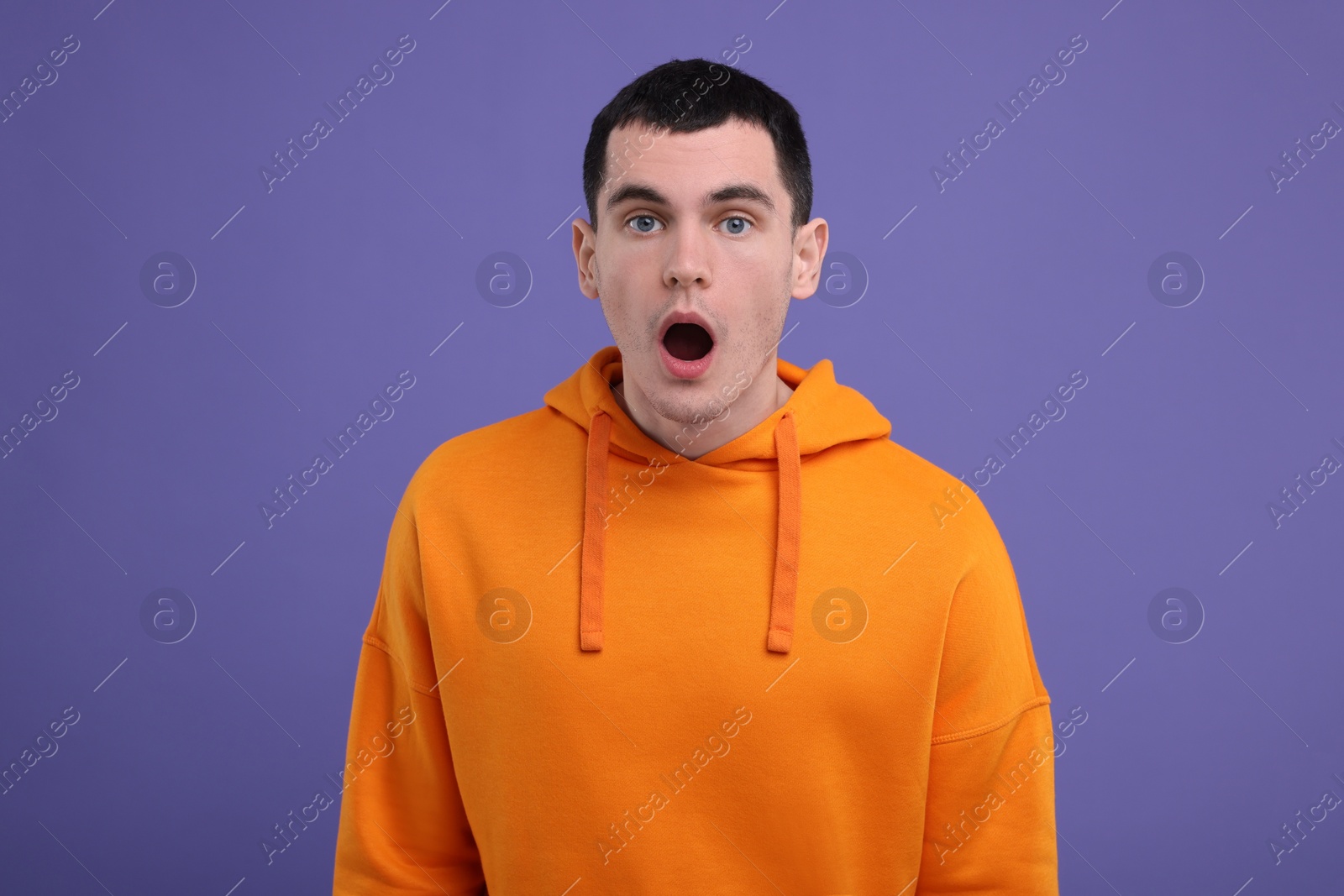 Photo of Portrait of surprised man on purple background