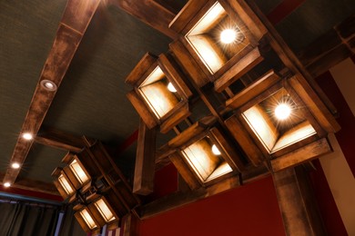 Photo of Stylish pendant lamps on ceiling in hotel room