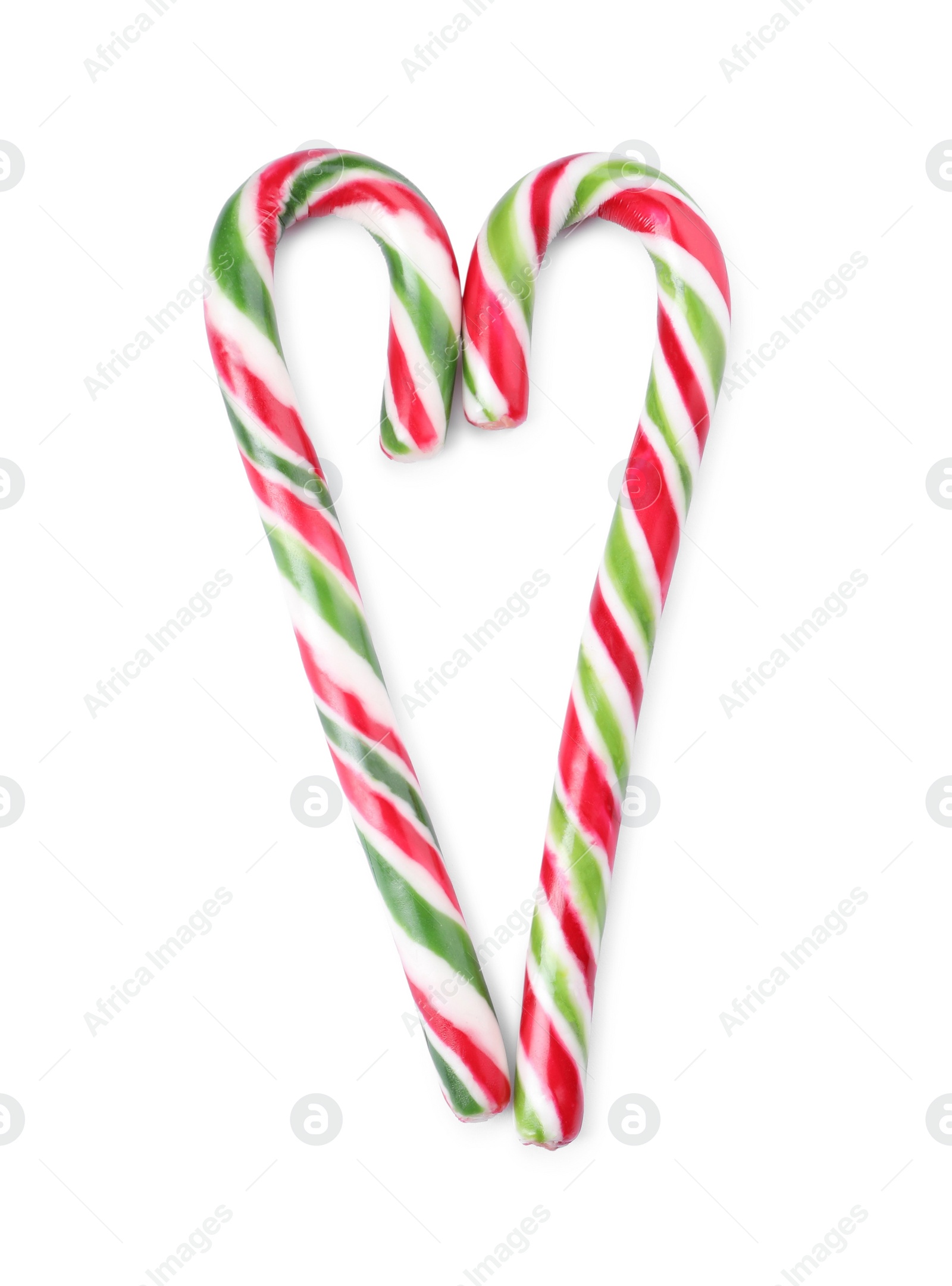 Photo of Heart made of sweet Christmas candy canes on white background