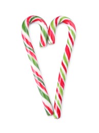 Photo of Heart made of sweet Christmas candy canes on white background