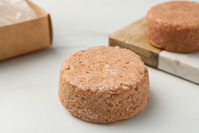 Photo of Natural solid shampoo bars on light table
