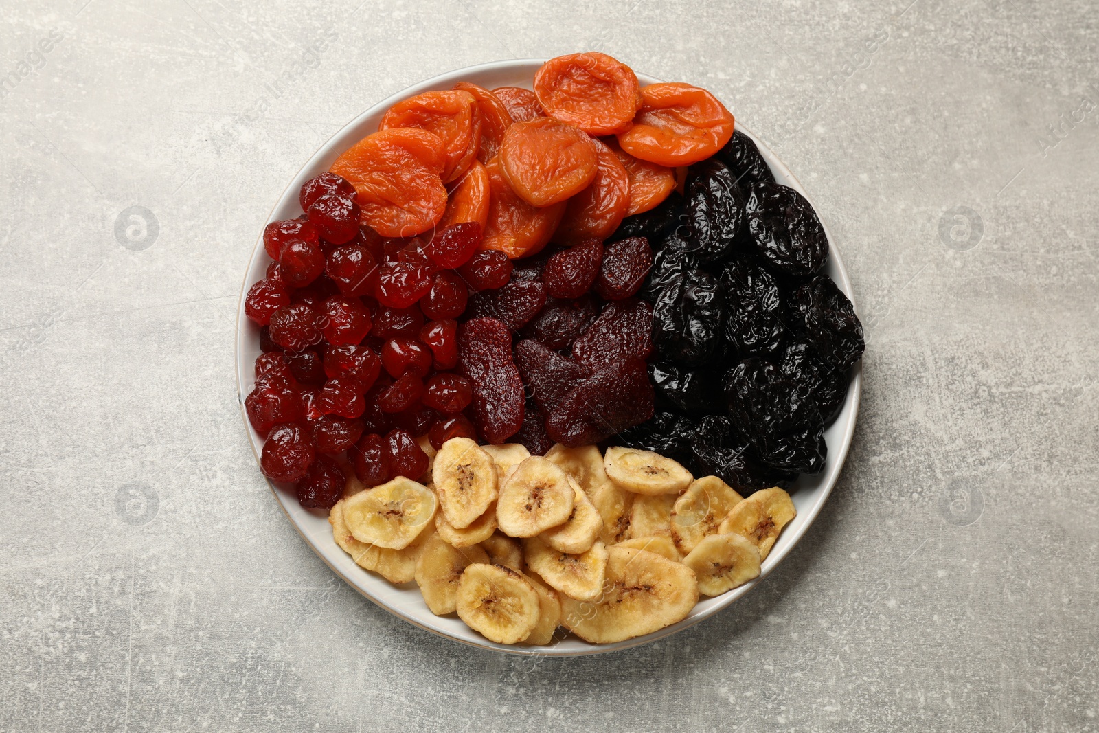 Photo of Delicious dried fruits on grey table, top view