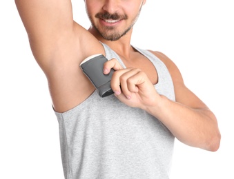 Photo of Young man using deodorant on white background, closeup