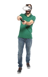 Photo of Emotional young man playing video games with virtual reality headset and controller isolated on white