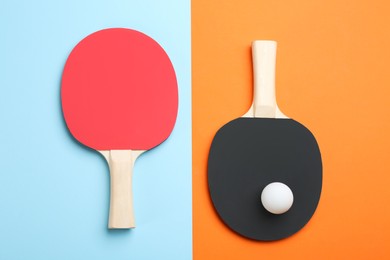 Photo of Ping pong rackets and ball on color background, flat lay
