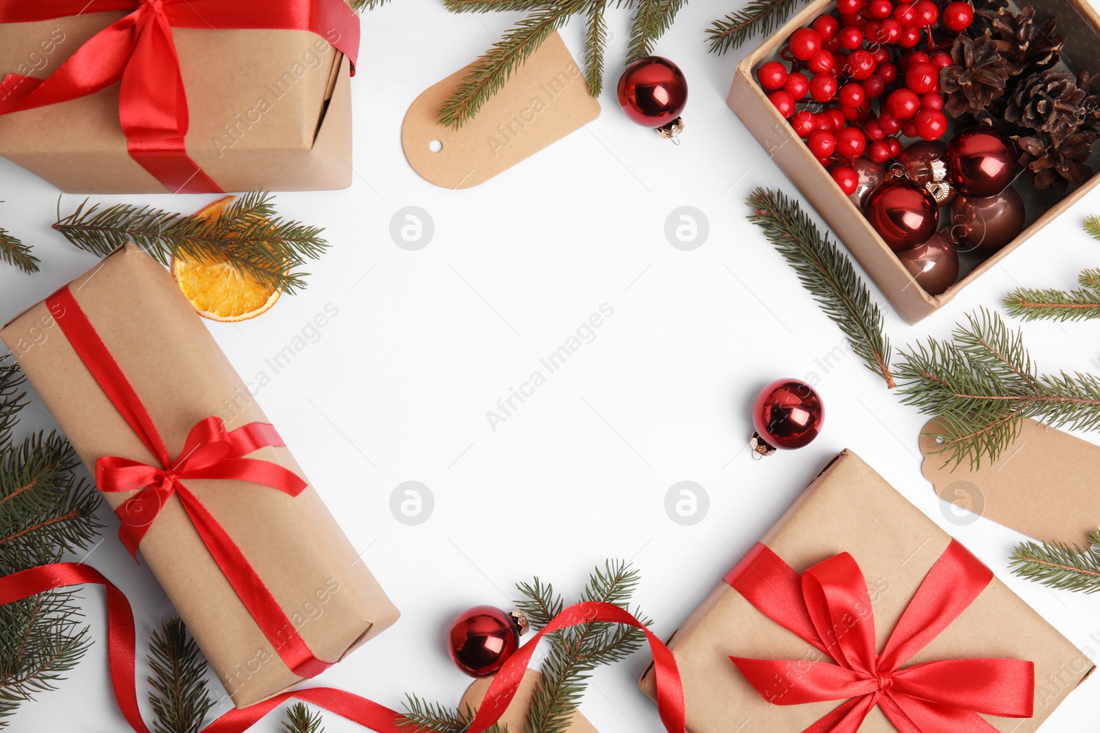 Photo of Frame of gift boxes and Christmas decor on white background, flat lay. Space for text
