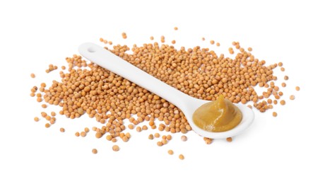 Photo of Fresh tasty mustard sauce in spoon and dry seeds isolated on white