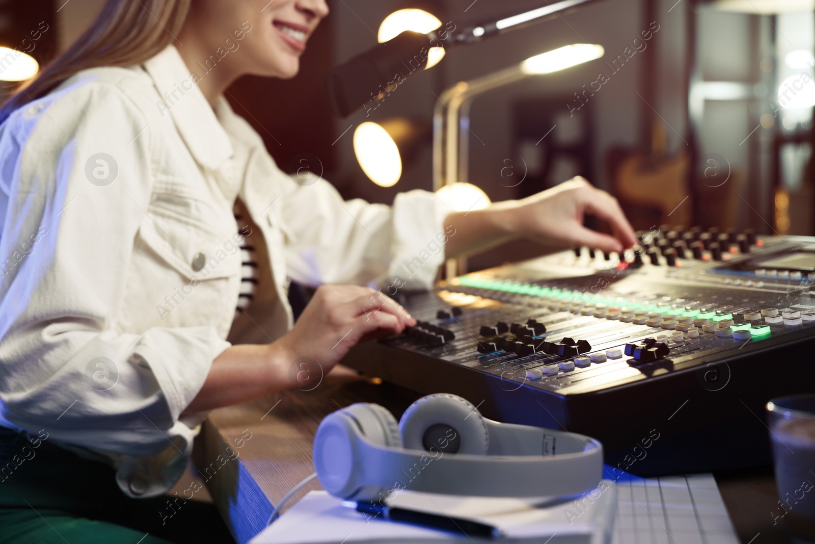 Photo of Woman working as radio host in modern studio, closeup