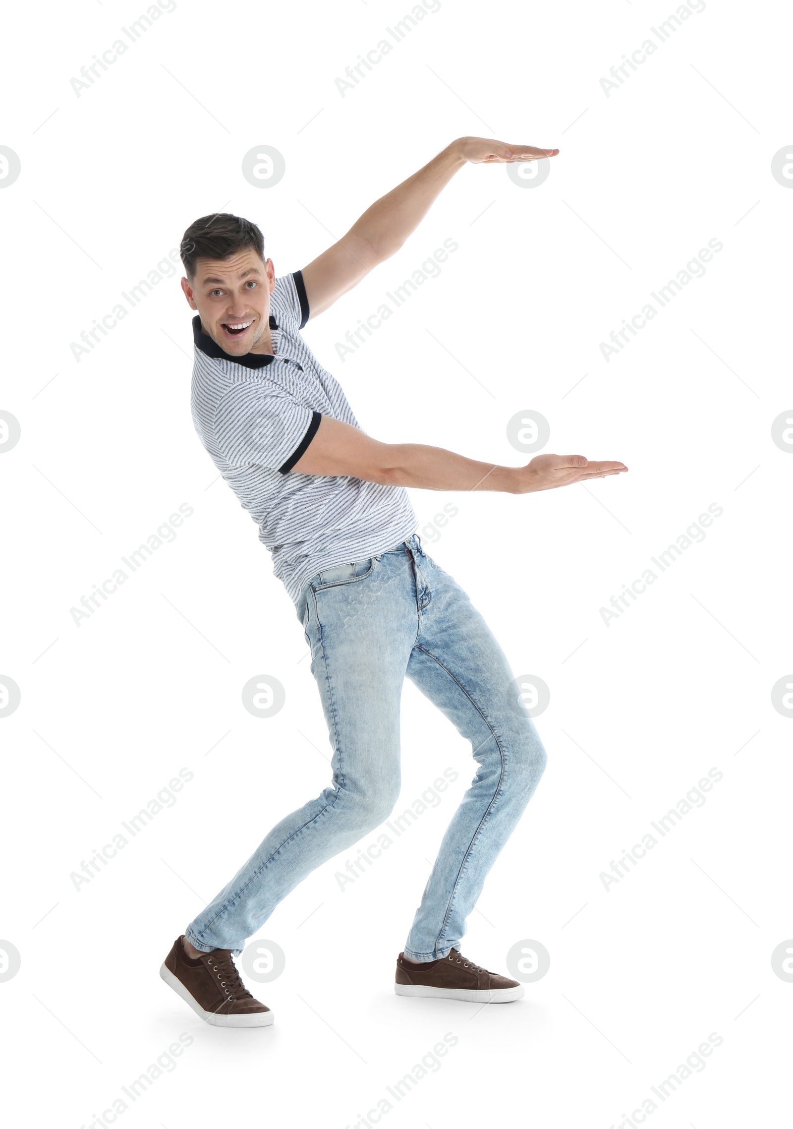 Photo of Emotional man in casual clothes holding something on white background