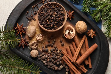 Photo of Different spices and fir branches on table, flat lay