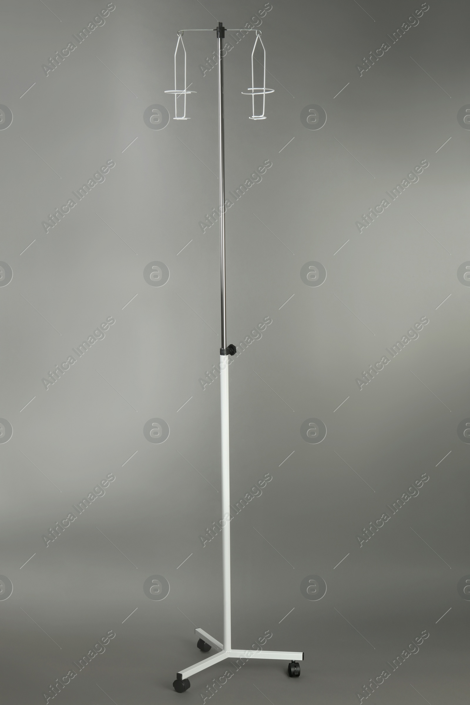 Photo of Drop counter stand on grey background. Medical equipment