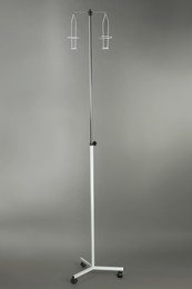 Photo of Drop counter stand on grey background. Medical equipment