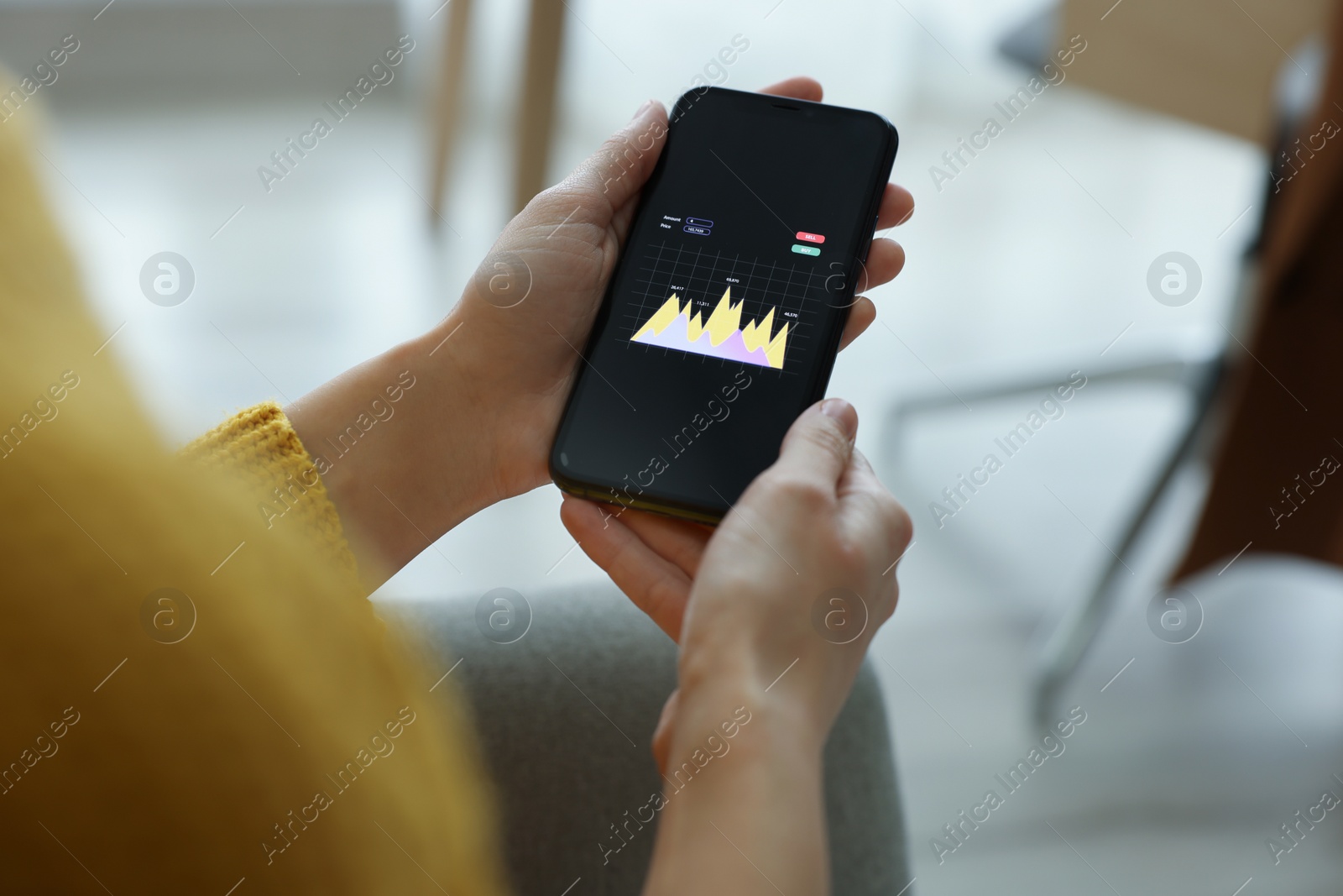 Photo of Woman working with smartphone indoors, closeup. Forex trading