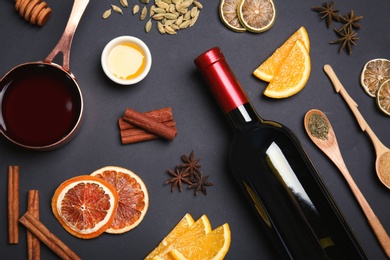 Photo of Flat lay composition with ingredients for mulled wine on black background