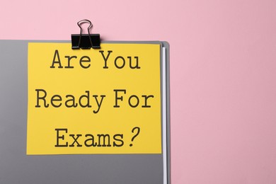 Photo of Sheet of paper with question Are You Ready For Exams? on light pink background, top view. Space for text