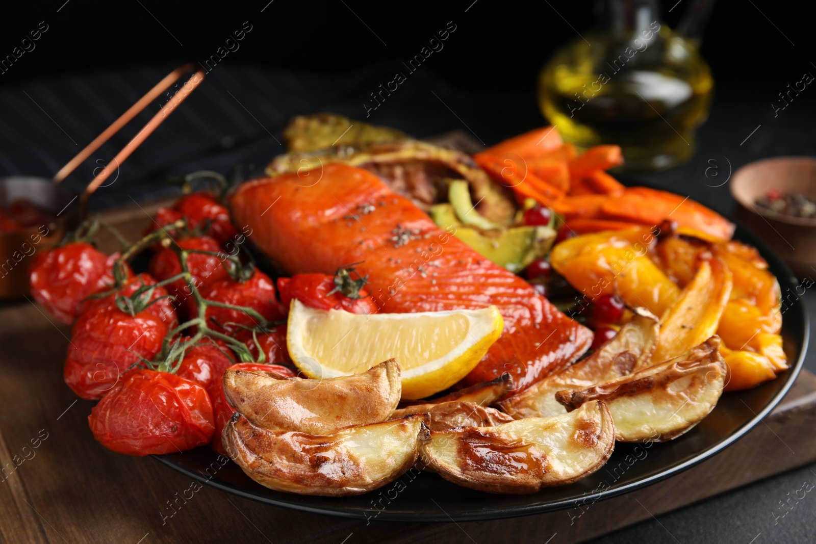 Photo of Tasty cooked salmon and vegetables served on table, closeup. Healthy meals from air fryer