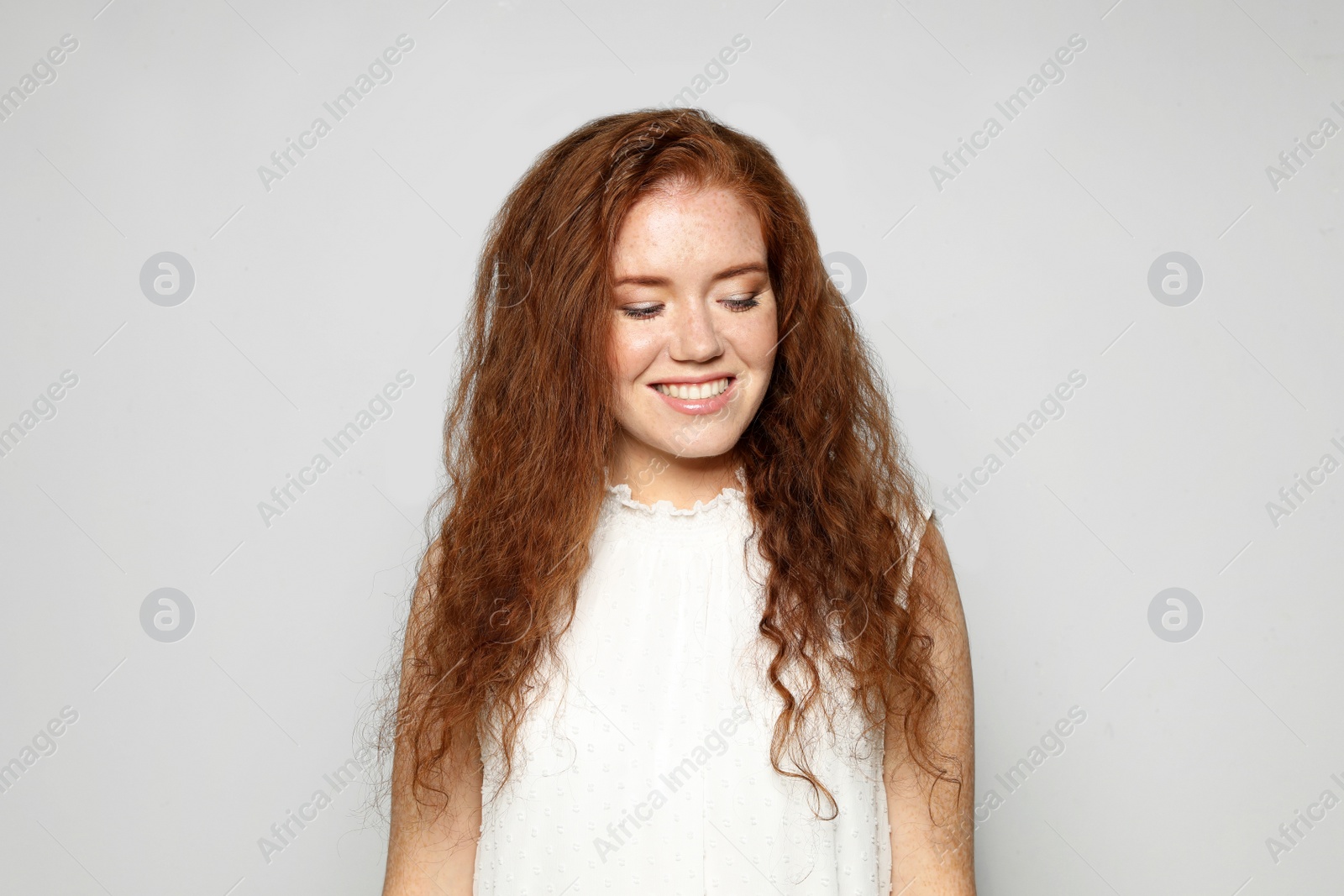 Photo of Portrait of young woman with beautiful face on grey background