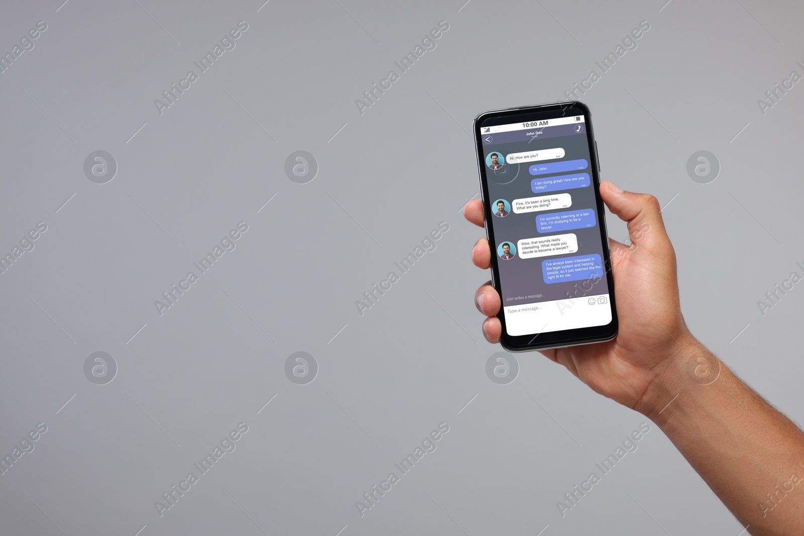 Image of Man texting with friend using messaging application on smartphone against grey background, closeup. Space for text