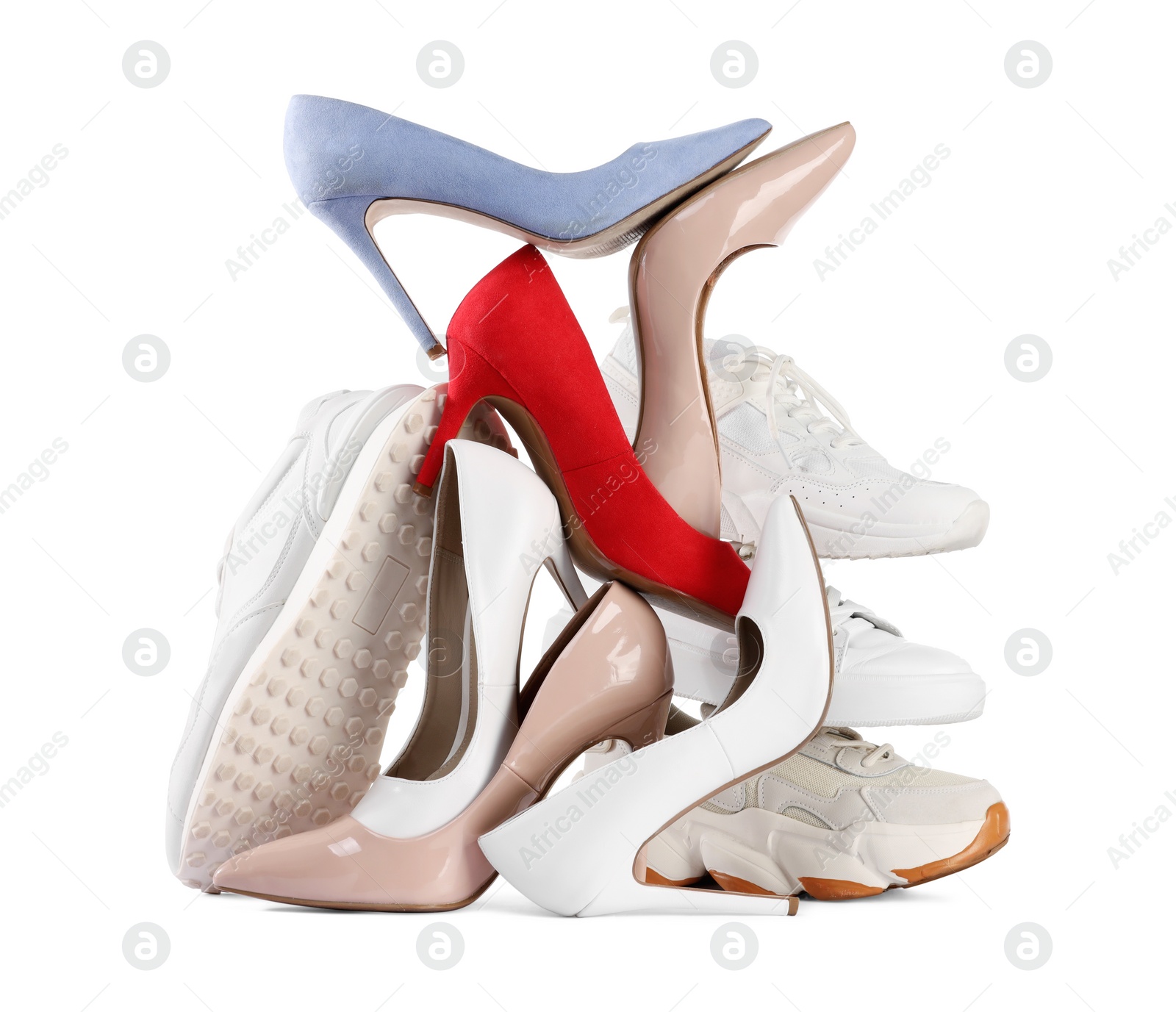 Photo of Pile of various female shoes isolated on white