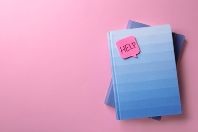 Photo of Notebooks and sticker with word HELP on color background, top view. Space for text