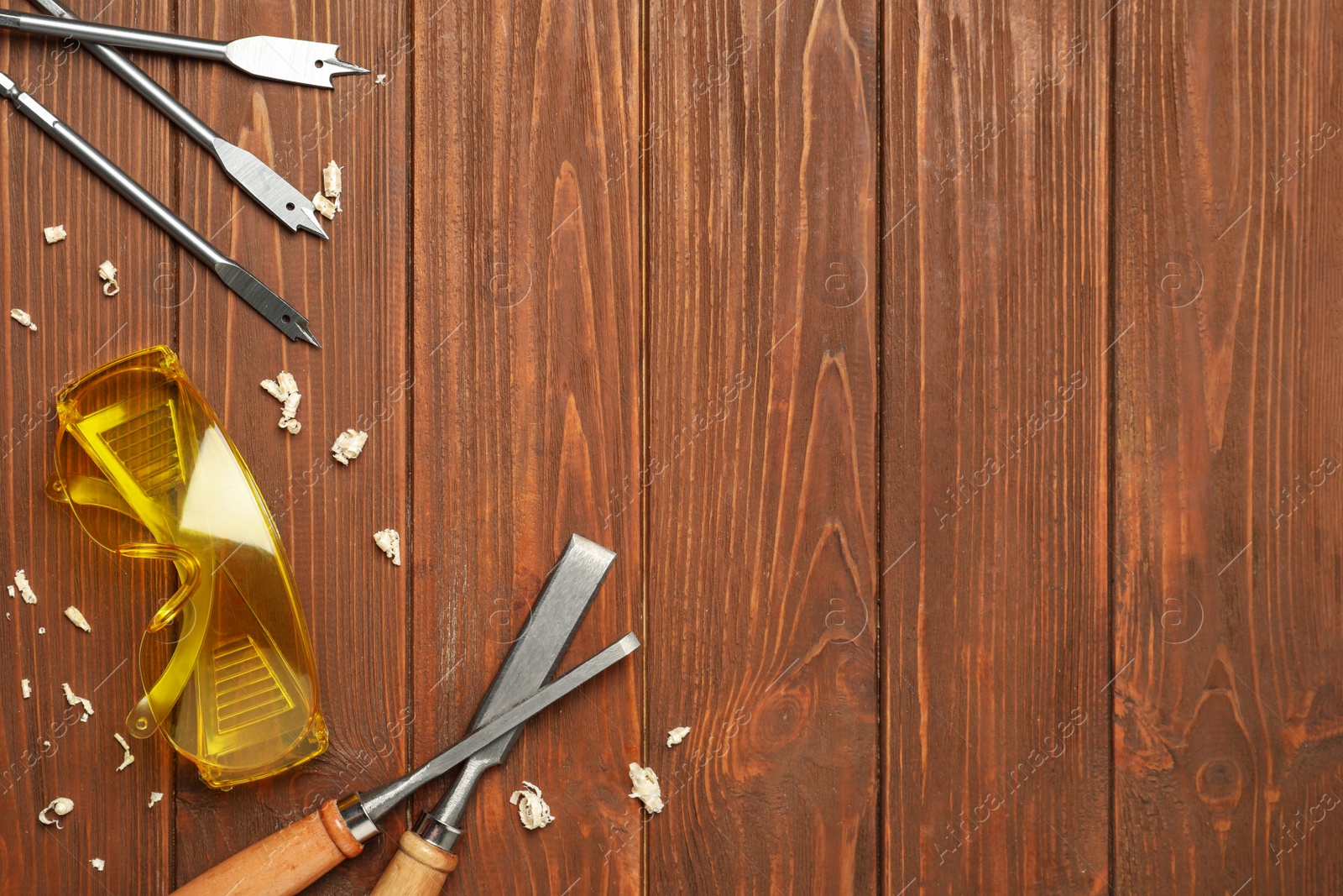 Photo of Flat lay composition with carpenter's tools on wooden background. Space for text