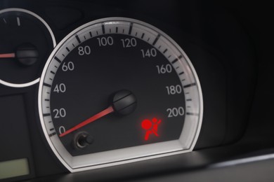 Closeup view of dashboard with warning icon check airbag system in car