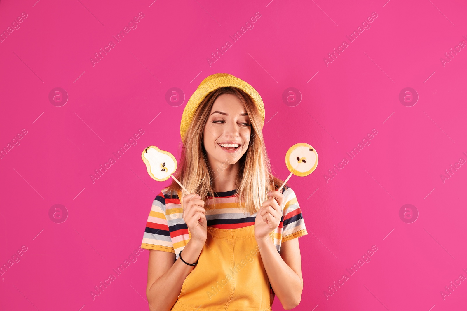 Photo of Young pretty woman with candies on colorful background