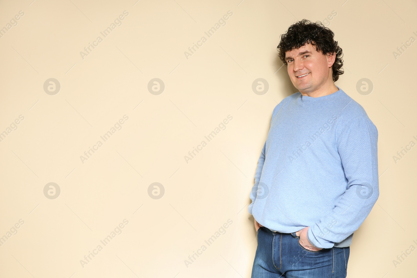 Photo of Portrait of handsome mature man posing on color background. Space for text