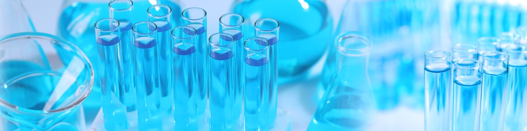 Chemistry and chemical research. Collage of different laboratory glassware with liquids, blue tone effect. Banner design