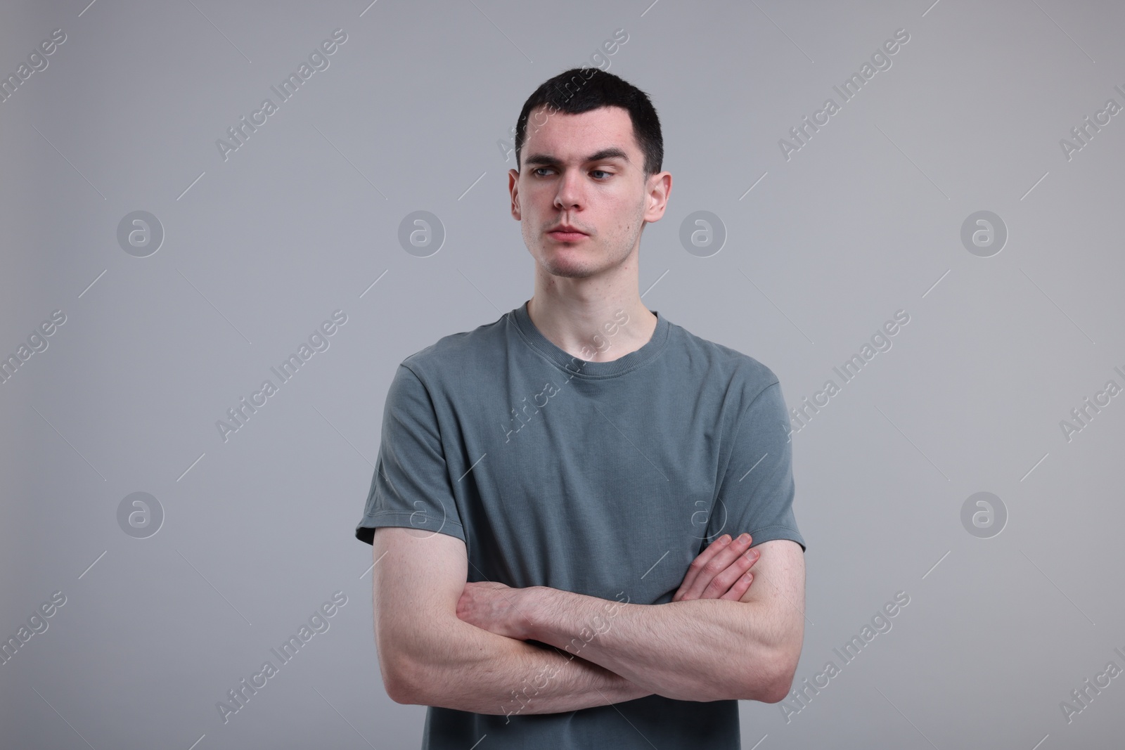 Photo of Portrait of frustrated man on grey background